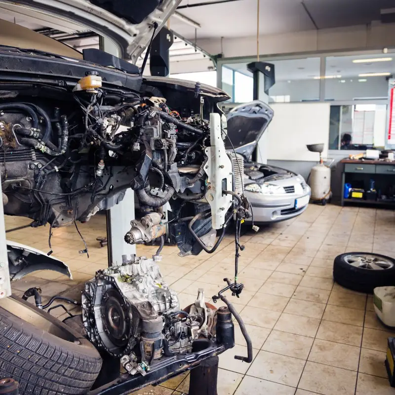Engine and transmission out of a car on the shop floor